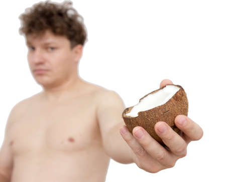 Coconut in a man's hand on a white backgroundの写真素材