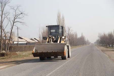 Old tractor on the roadの写真素材
