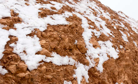 snow on red clay in natureの写真素材