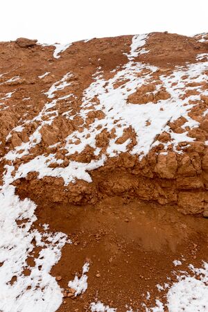 snow on red clay in natureの写真素材