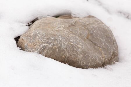 stones in the snow on the natureの写真素材