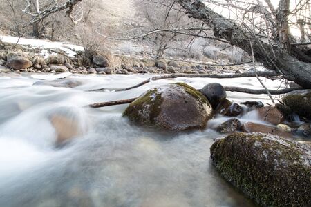mountain river in the winter in natureの写真素材