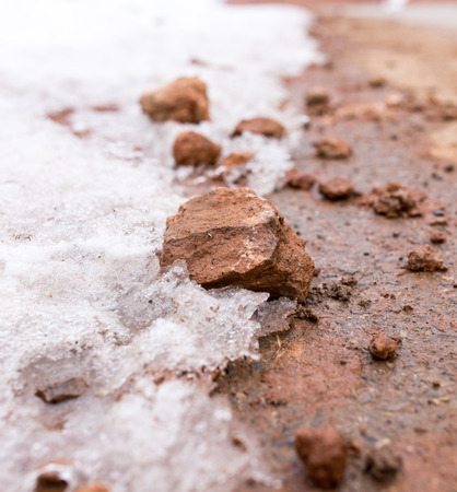snow on red clay in natureの写真素材