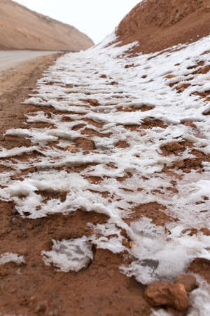 snow on red clay in natureの写真素材