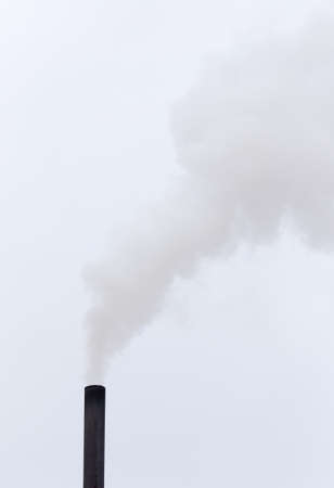 Smoke from a pipe on a cloudy skyの写真素材