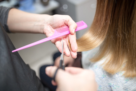 Female hair cutting scissors in beauty salonの写真素材