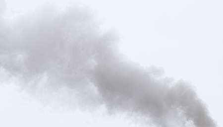 Smoke from a pipe on a cloudy skyの写真素材