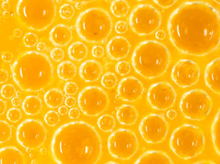 foam on a yellow egg yolk as a background. macroの写真素材