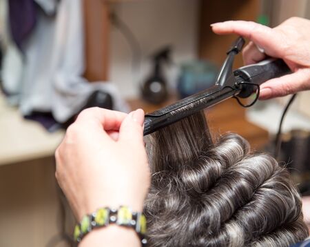 wrap hair curling in a beauty salonの写真素材