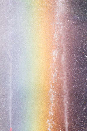 Rainbow in the fountain as a backdropの写真素材