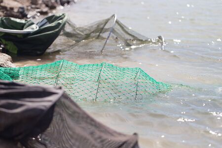 fish in cages in the waterの写真素材