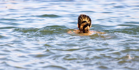 Girl swims in the lake