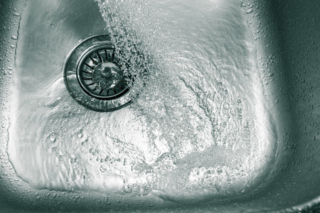 Water from the tap in the sinkの写真素材