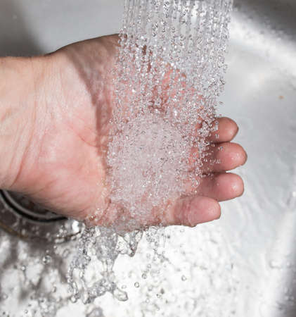 hand in the water in the sinkの写真素材