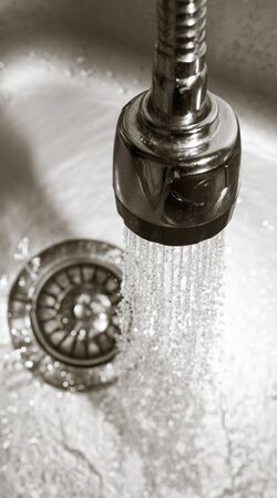 Water from the tap in the sinkの写真素材