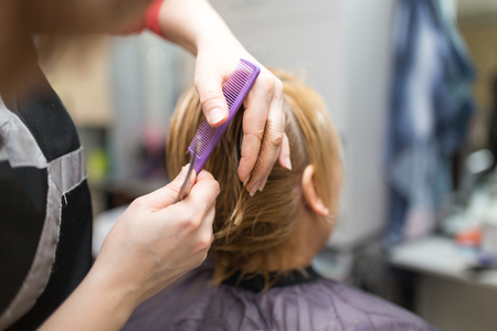 Female hair cutting scissors in beauty salonの写真素材