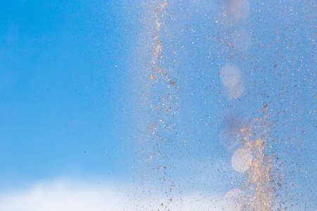 water splashing from the fountain in the background of blue sky