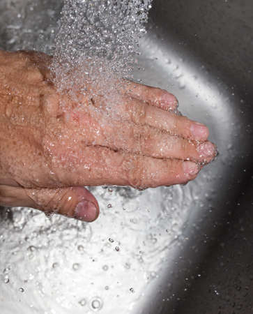 hand in the water in the sinkの写真素材