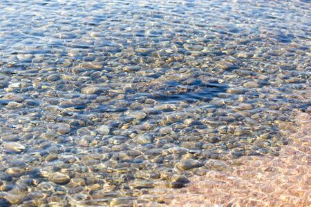stones under the surface of the water in nature