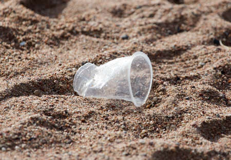 plastic cup on the sand