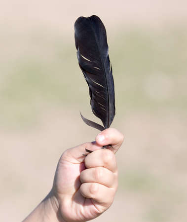 a feather in his hand boyの写真素材