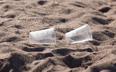 plastic cup on the sandの写真素材
