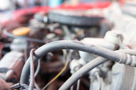 motor and hoses under the hood of car