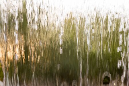 Water from the waterfall as a backdropの写真素材