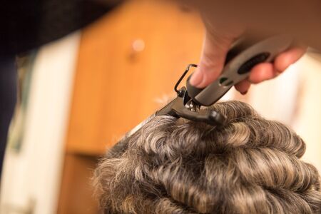 wrap hair curling in a beauty salonの写真素材