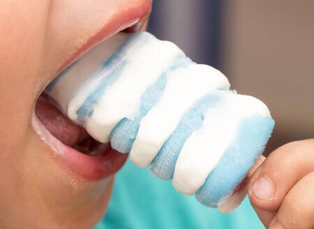 Boy eats ice creamの写真素材