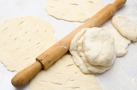 rolling dough with a rolling pin