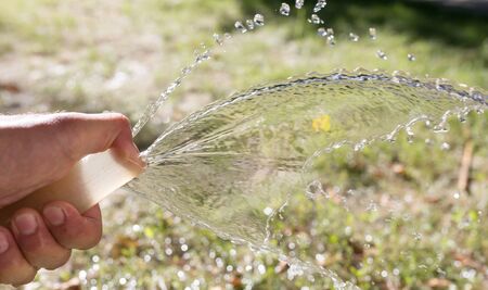 water from the hose outdoorsの写真素材