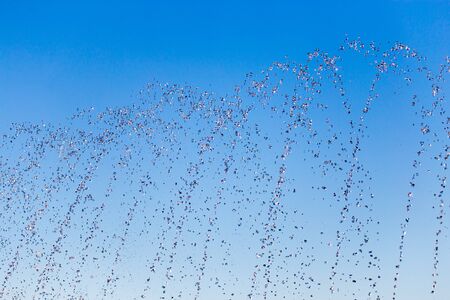 water splashing from the fountain in the background of blue skyの写真素材