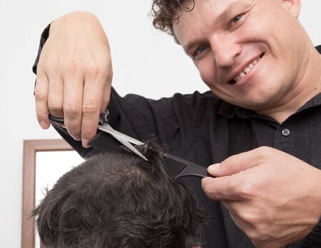 hairdresser cuts men's hair cutの写真素材