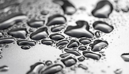 drops of water on a dark carの写真素材