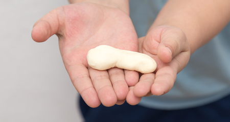 boy with his hands in the doughの写真素材