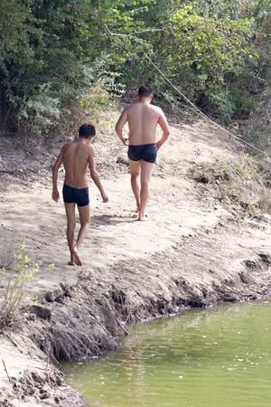 two men on the river swimmingの写真素材
