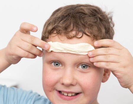 boy playing with doughの写真素材