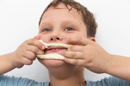 boy playing with doughの写真素材