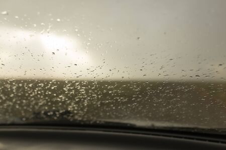raindrops on a windshield of carの写真素材