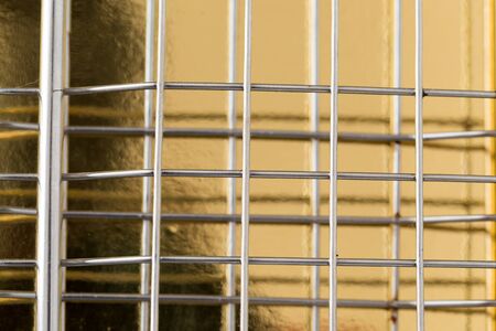 metal mesh on a gold backgroundの写真素材