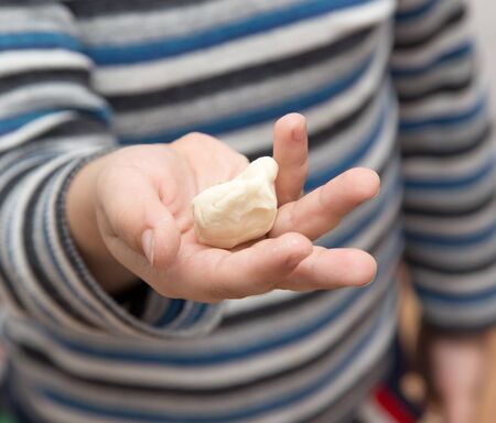 boy with his hands in the doughの写真素材