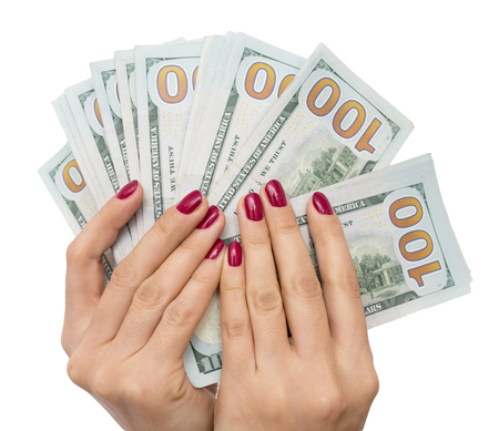 dollars in the hand of the girl on a white backgroundの写真素材