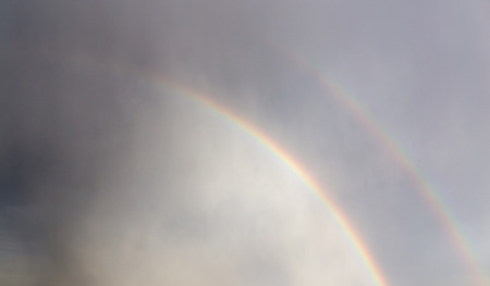 rainbow in the sky after the rainの写真素材