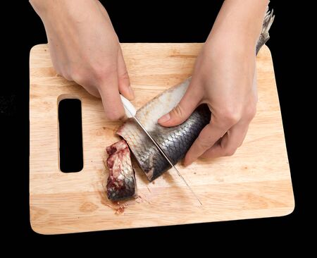 preparation of herring on a board on a black backgroundの写真素材