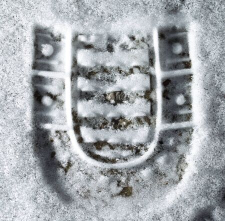 trace of the shoe in the snow as a background