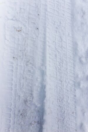 trace of the car in the snow as a backgroundの写真素材