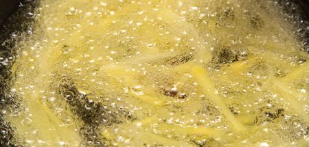 cooking potato fries in oilの写真素材