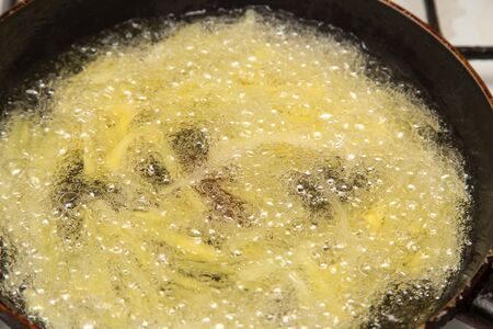 cooking potato fries in oilの写真素材