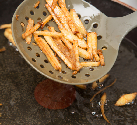 cooking potato fries in oilの写真素材
